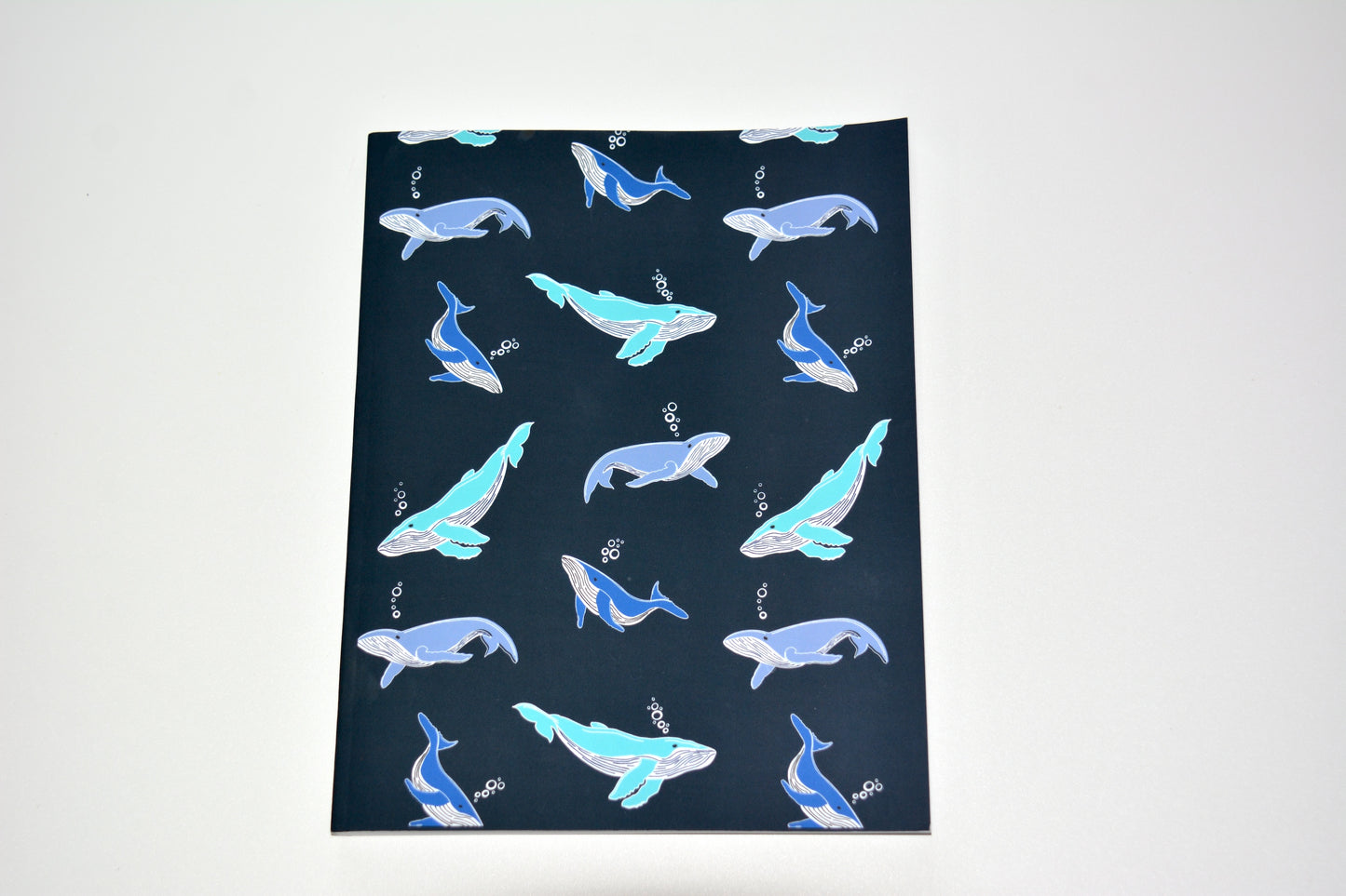 whale pattern notebook on navy blue background