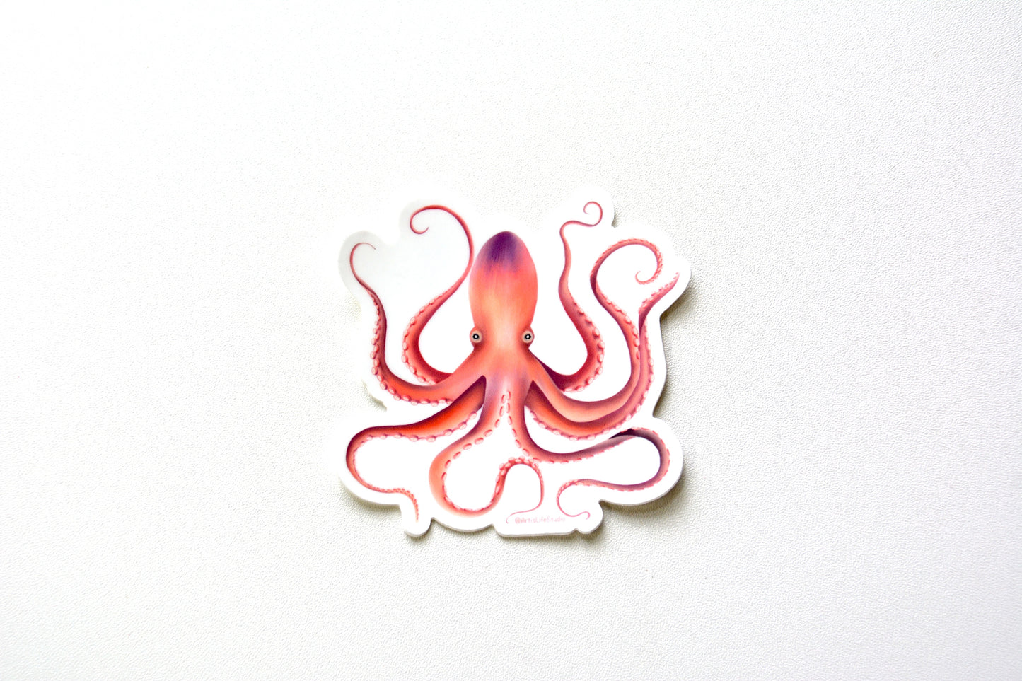 vinyl Sticker of a pink orange and purple octopus on white background