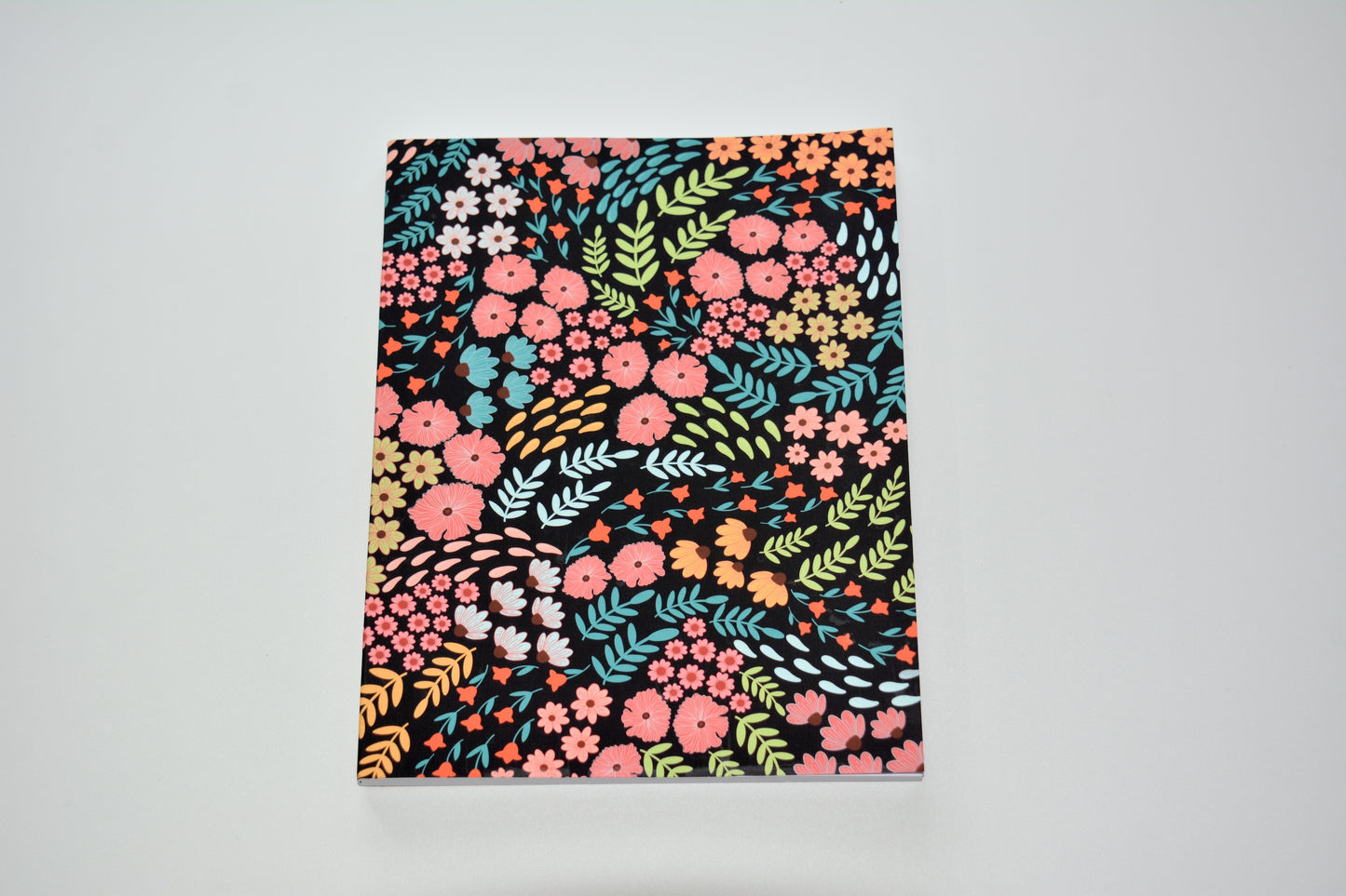 Notebook with a colorful floral and leaves pattern 
