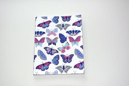 Notebook with artist designed butterfly pattern on a white background