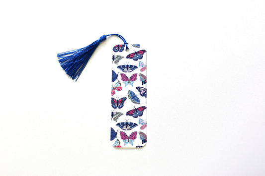 Bookmark with hand illustrated butterfly pattern and blue tassel on a white background