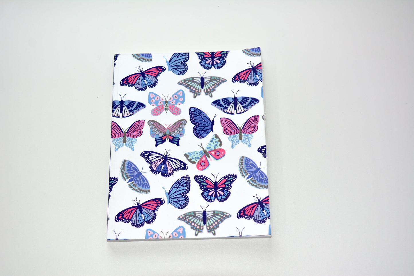 Notebook with butterfly pattern on a white background
