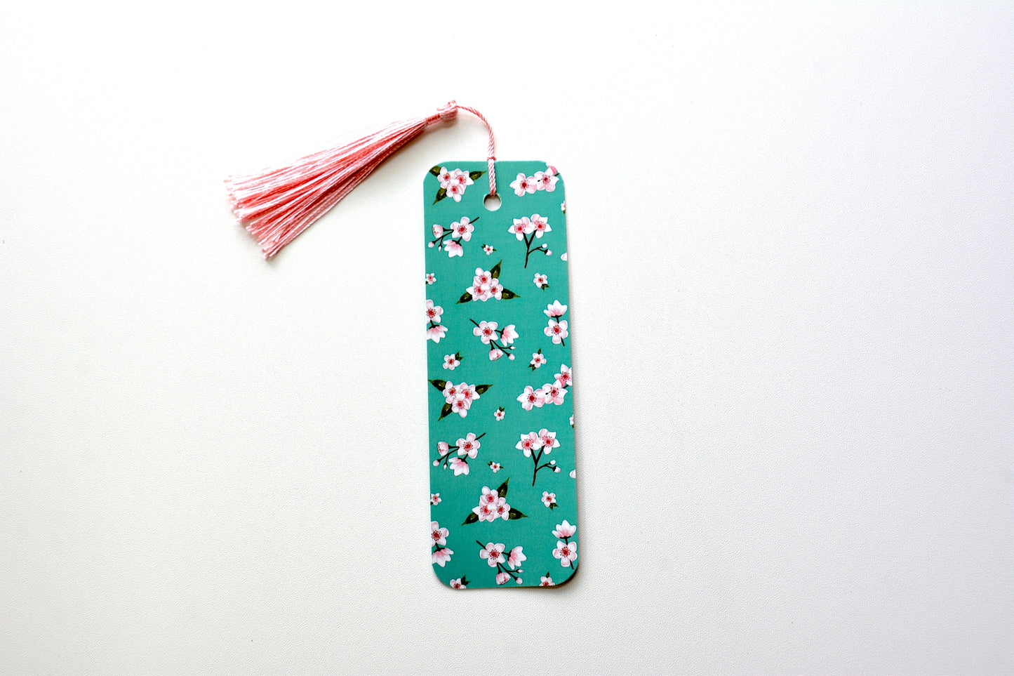Cherry blossom Floral pattern bookmark with a pink tassel on a white background