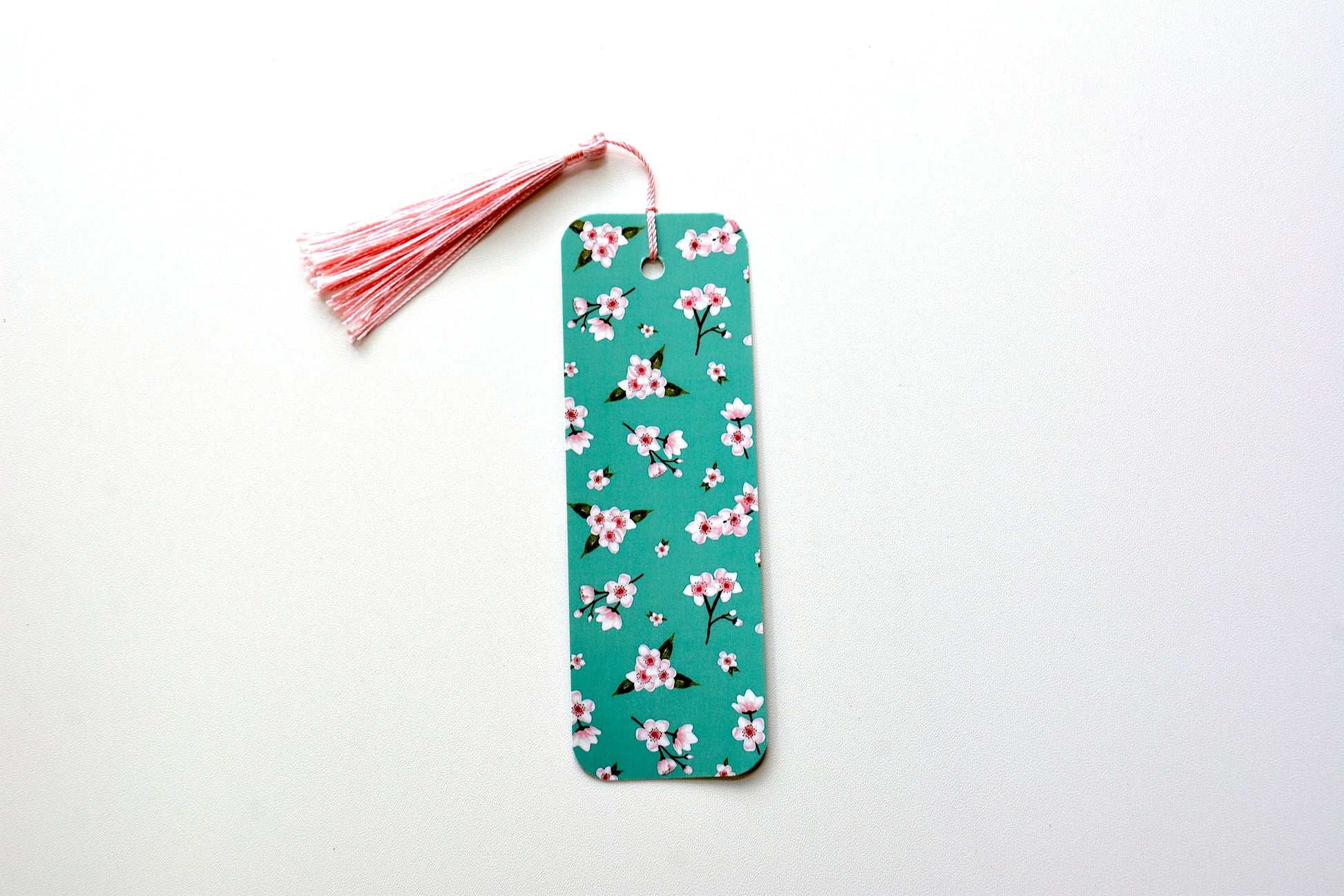 Cherry blossom Floral pattern bookmark with a pink tassel on a white background