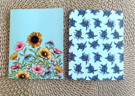 floral and turtle design undated planner covers on a textured surface