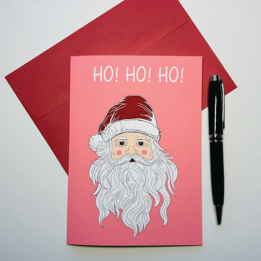 Pink card with Santa Claus illustration and 'HO! HO! HO!' text with red envelope, and black pen on a white background