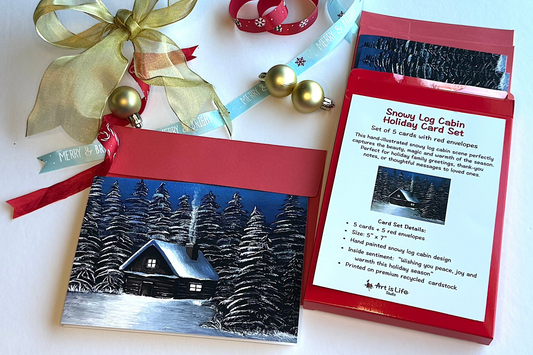painted Snowy Log Cabin Holiday Card Set with packaging on a white background
