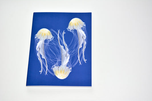 Notebook of artist designed jellyfish on blue background