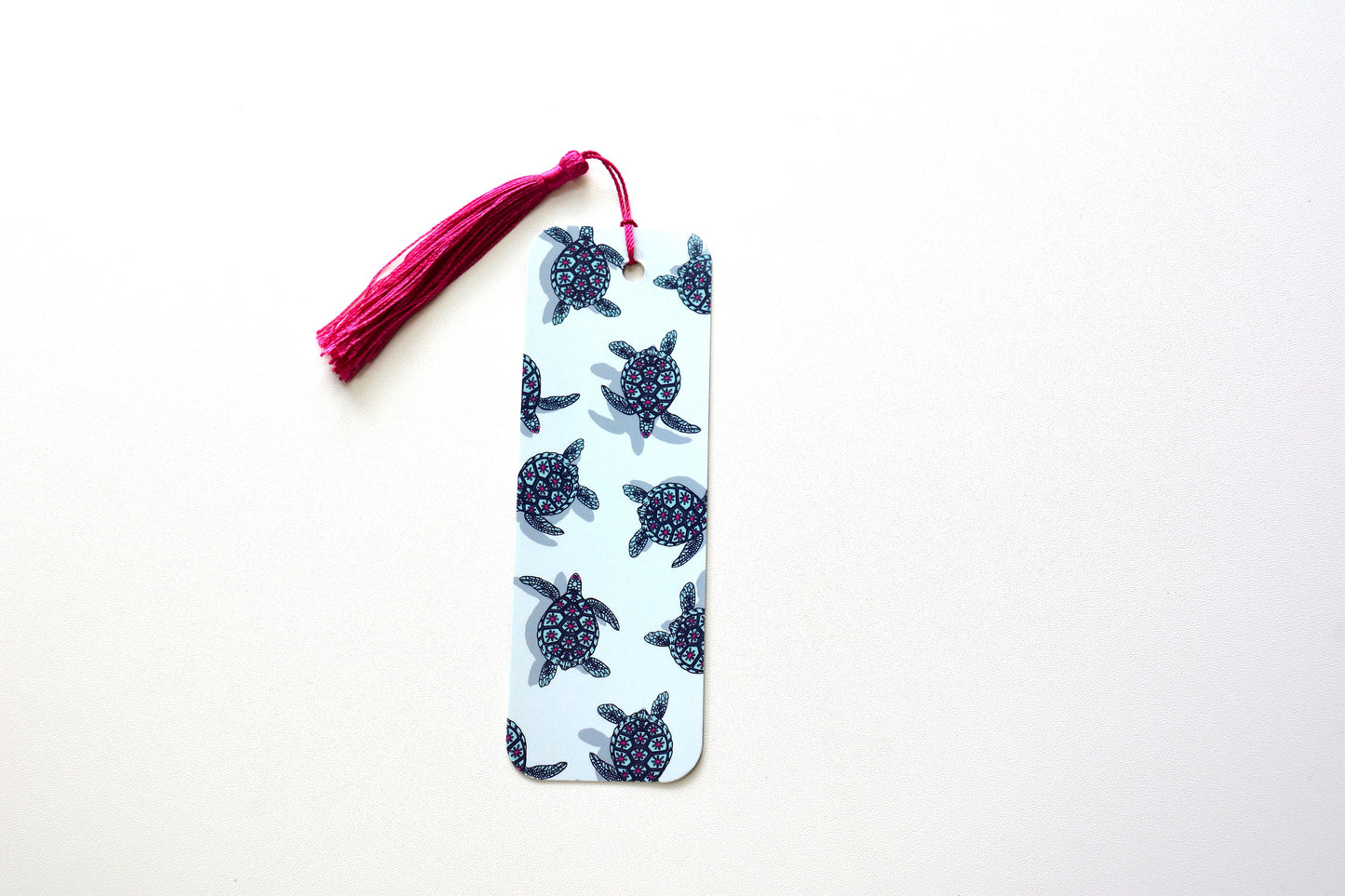 Bookmark with turtle pattern and pink tassel on a white background